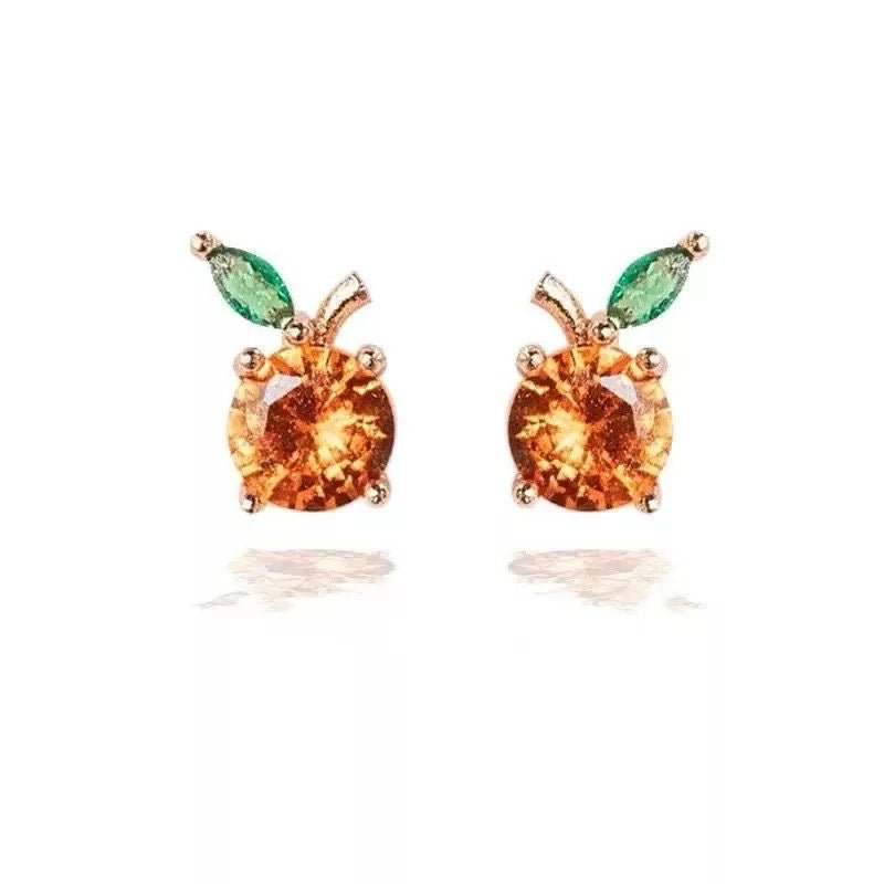 Mini fruit-shaped gold-filled stud earring on white background